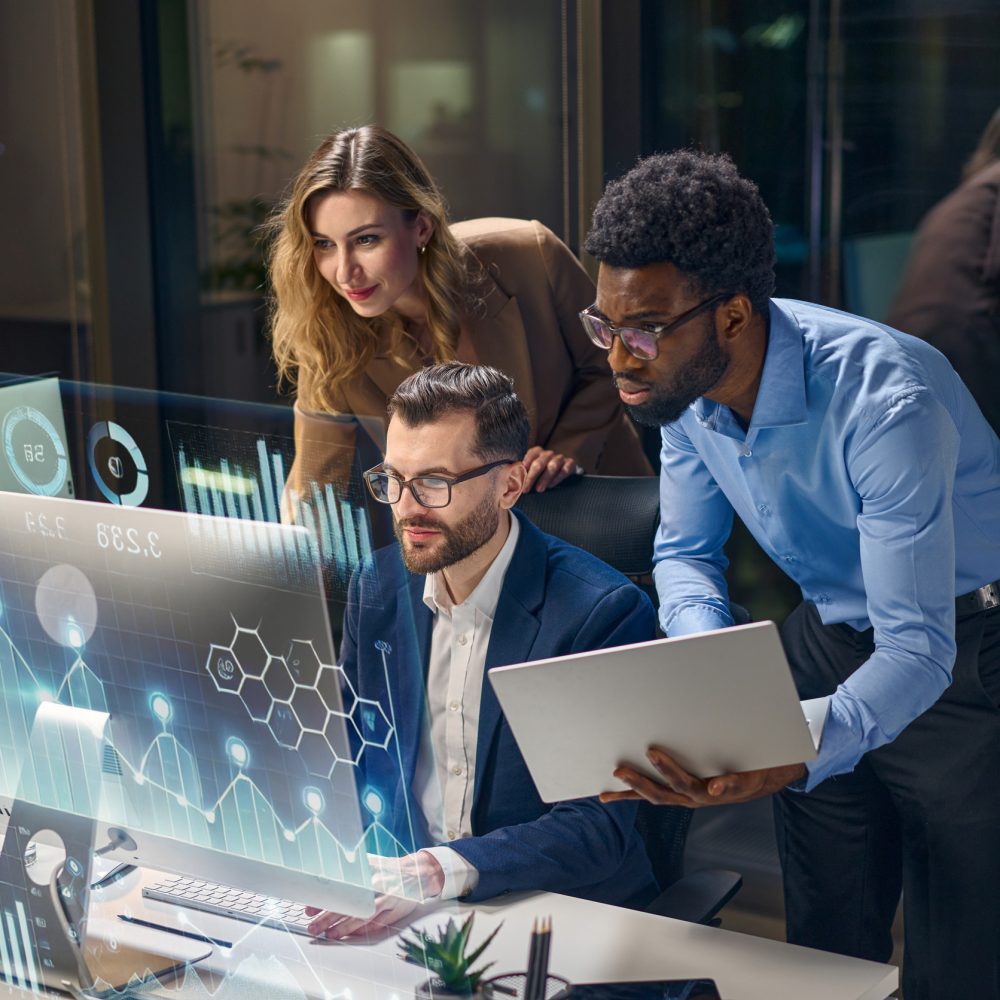 Diverse Team Collaborating on Business Analytics with Digital Visualization in Modern Office Team Analyzing Data Using Innovative Technology With Futuristic Digital Interfaces and Displays